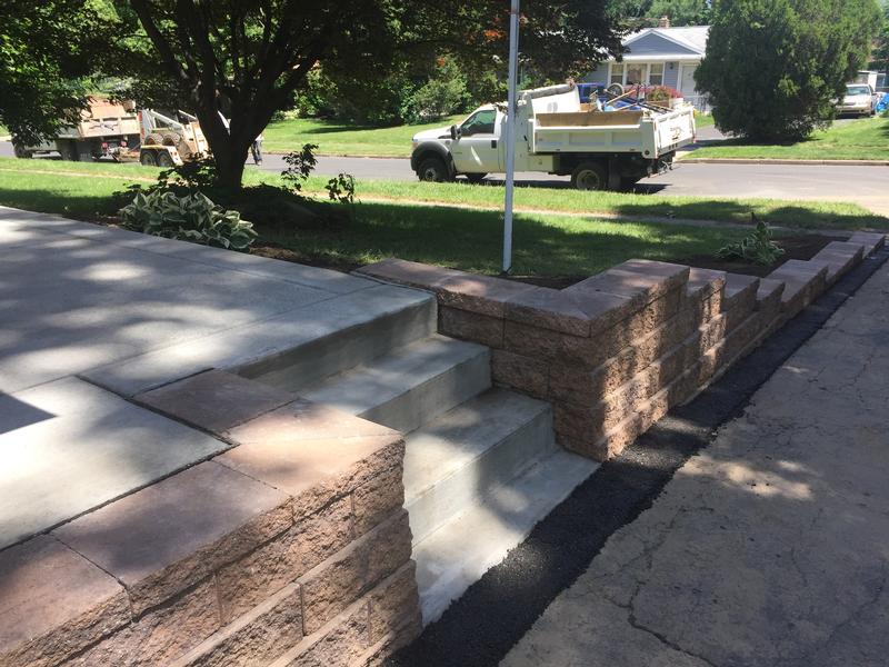 concrete patio steps and paver retaining wall